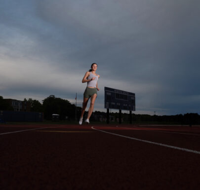 Senior runner portrait with strong dynamic lighting in Newton MA