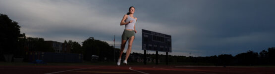 Senior runner portrait with strong dynamic lighting in Newton MA