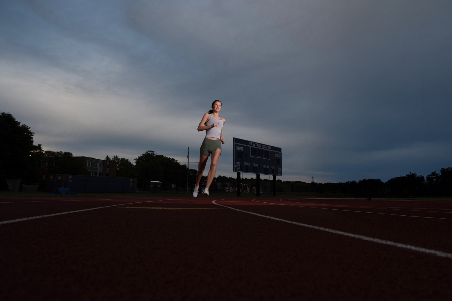 Senior runner portrait with strong dynamic lighting in Newton MA