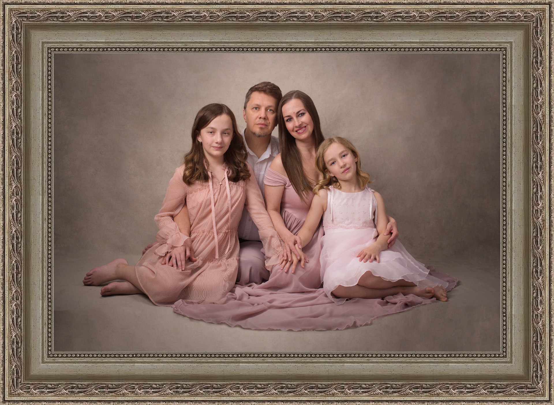 Family wall art display in a bright living room showing printed portraits created by Adriana Kopinja Photography in Newton