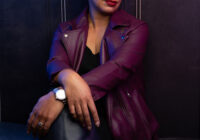 Woman over 50 wearing a plum leather jacket, seated confidently with eyes closed, photographed at a Newton, MA portrait studio as part of the Unstoppable Women campaign.